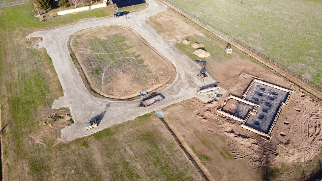 Construction equipment works on the foundation of a new building.